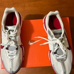 Nike men’s gym shoes. They are white with red and silver. Size 9